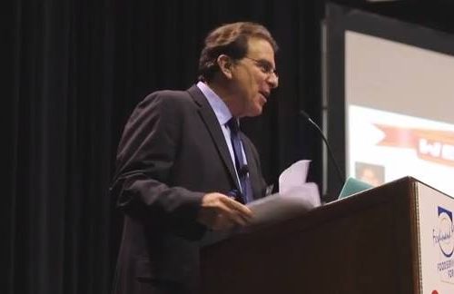 Scott Cooper speaking at podium